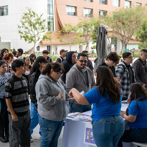 Crowds of hopeful Los Angeles young adults receive personalized assistance from EWDD staff at a Hire LA Day event